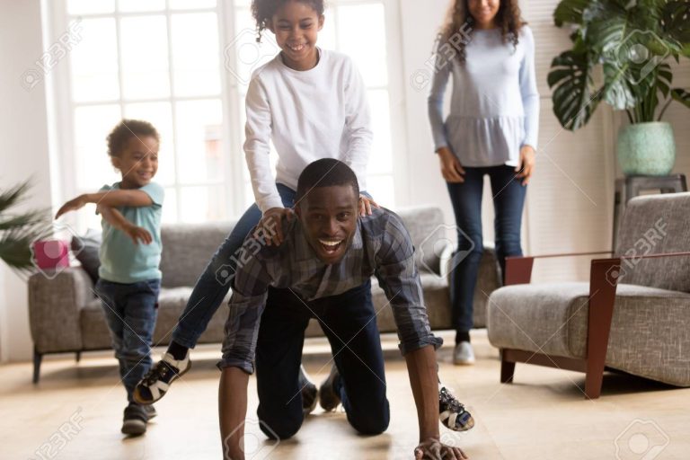 Father ride daughter on his back have a fun indoors